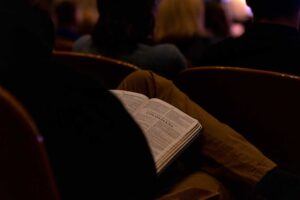 A student holding a bible in their lap during chapel