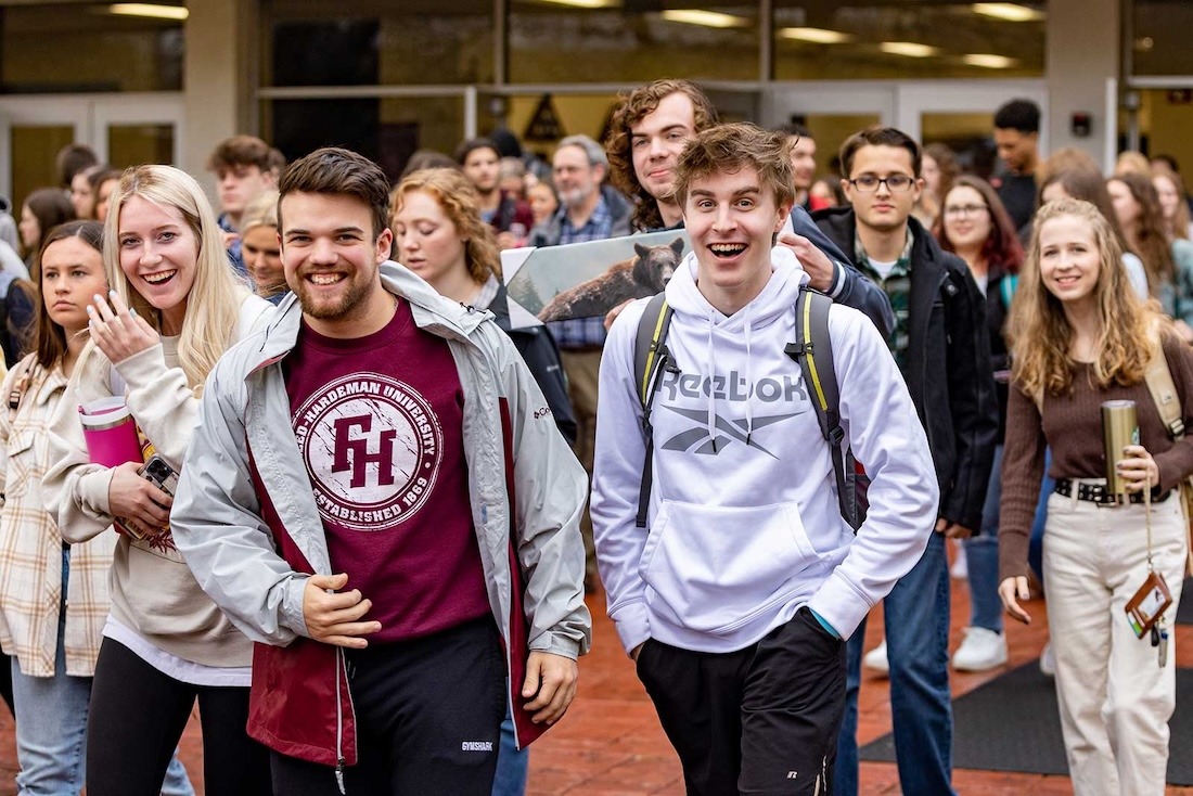 A mass of students rushing to lunch after chapel