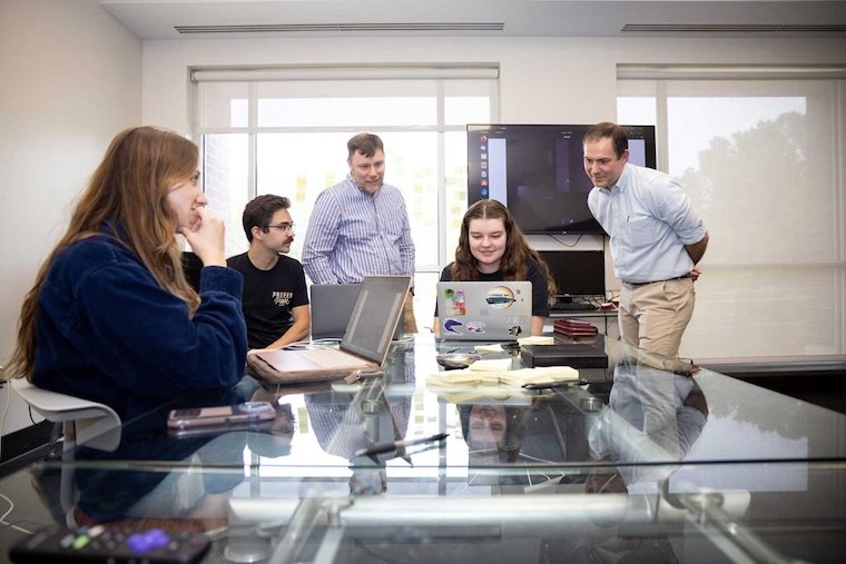 Computer science professors helping their students