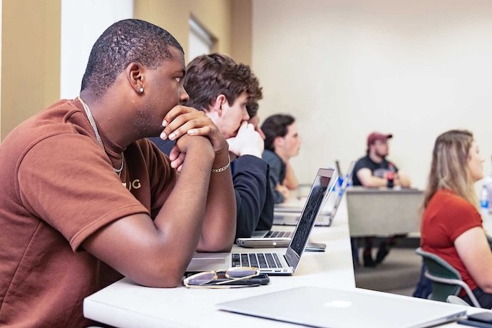 Students listening to their professor in class