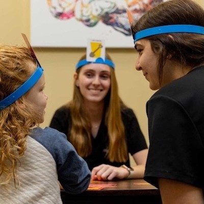 students playing a game with a kid