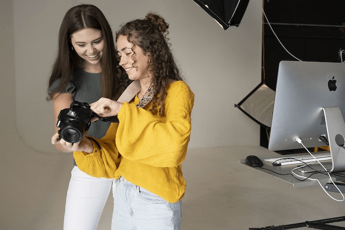 Two photography students review the pictures they just shot
