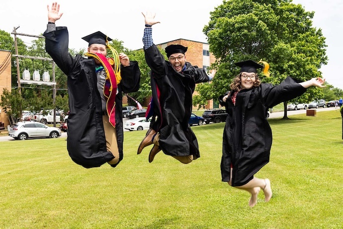 Dr. Sokoloski celebrating with a couple of students after their graduation