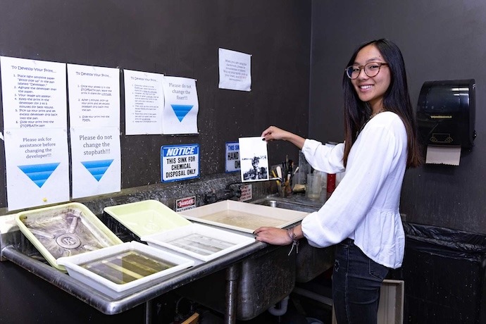 A student developing photographs