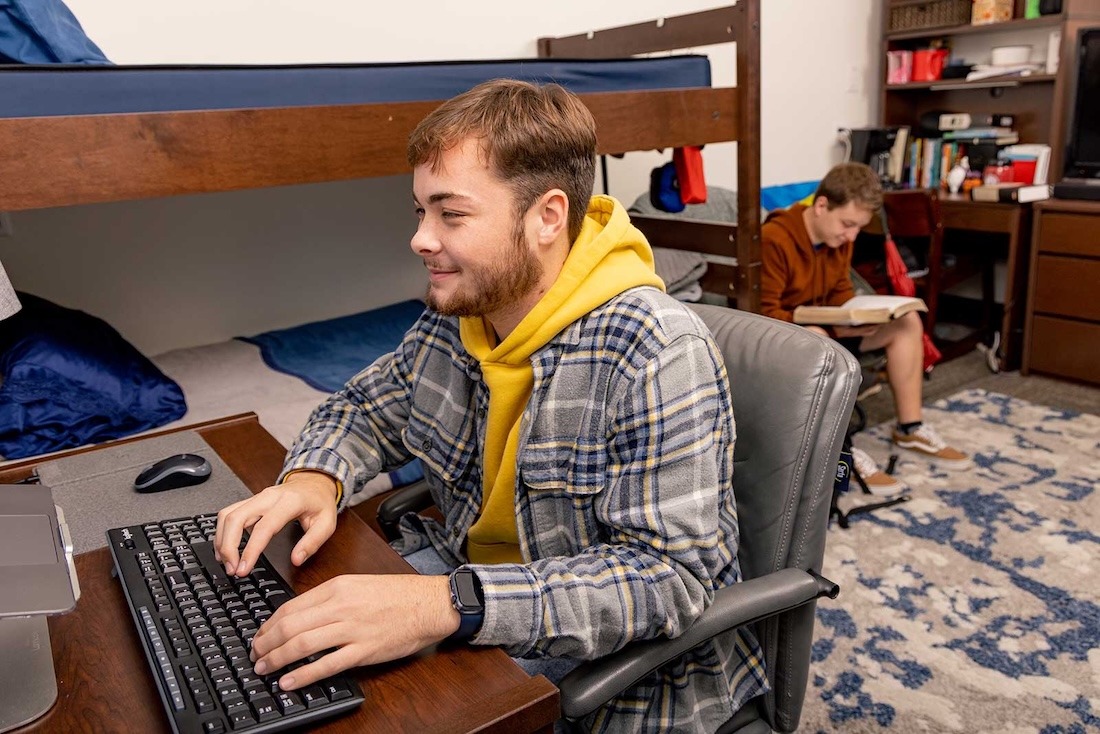 A couple of students studying in their dorm room