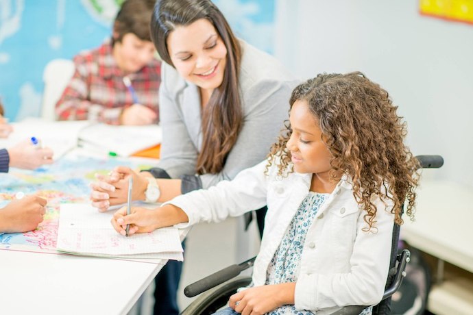 A teacher helping her student
