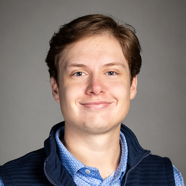 Will Rawson, a man with short combed brown hair and a clean shaven face